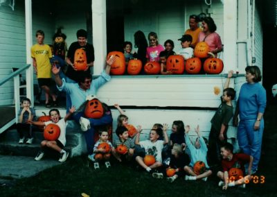 group of children and pumpkins on the steps of the grange