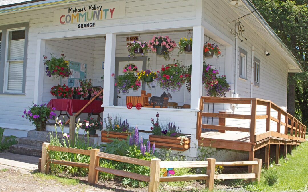 the grange porch full of hanging flower pots